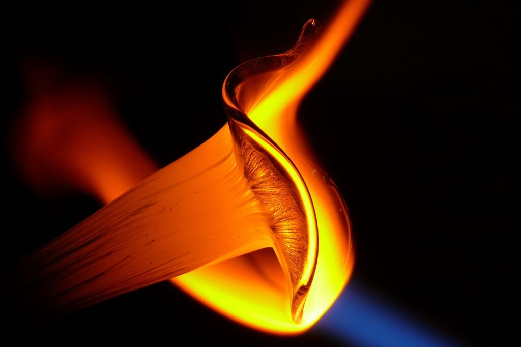 Red and orange glowing molten glass on a black background.