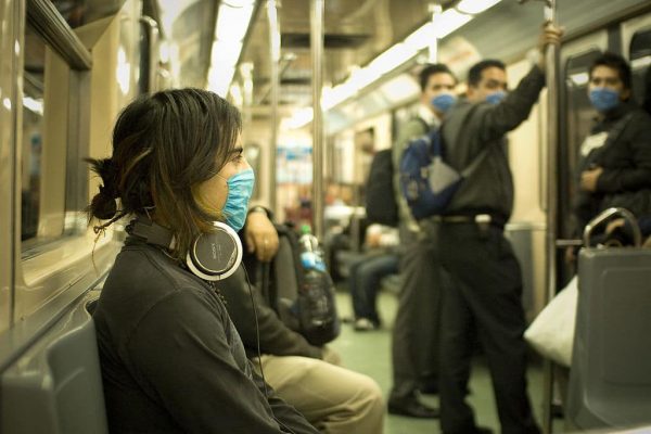 1024px-Swine_Flu_Masked_Train_Passengers_in_Mexico_City