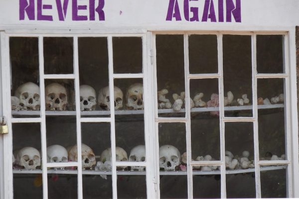 Never_Again_-_With_Display_of_Skulls_of_Victims_-_Courtyard_of_Genocide_Memorial_Church_-_Karongi-Kibuye_-_Western_Rwanda_-_02-scaled