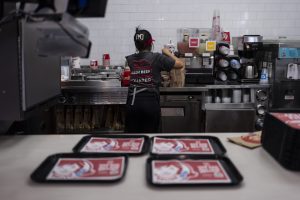 Part-time employee Adriana Ruiz, 18, works on an order in the kitchen at a Wendy's restaurant owned by Lawrence Cheng and his family in Fountain Valley, Calif., June 20, 2024. California's minimum wage increase that went into effect in April and saw fast food workers across the state go from making $16 to $20 overnight is already having an impact on local operators who say they are reducing worker hours and raising menu prices as the sudden increase in labor costs leaves them scrambling for solutions.  (AP Photo/Jae C. Hong)