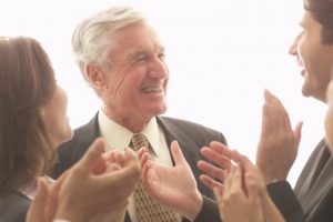 Colleagues Applauding Senior Businessman